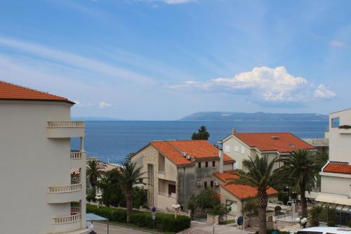 a group of buildings with the ocean in the background at Apartmani Milkovic in Tučepi