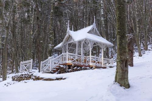 a gazebo in the snow in the woods at Aldea Nevada in Ushuaia