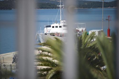a boat docked at a dock in the water at Apartments and Rooms Jospino in Mali Lošinj