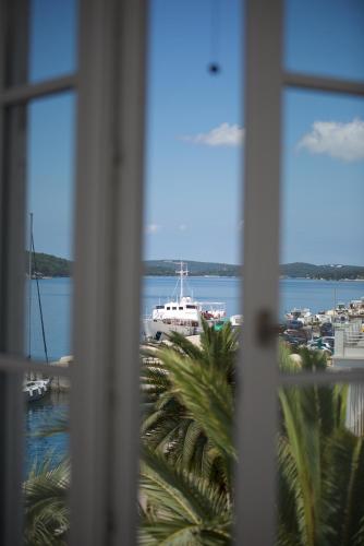 a view of a harbor from a window at Apartments and Rooms Jospino in Mali Lošinj