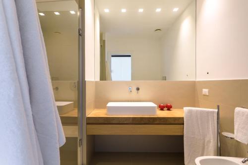 a bathroom with a sink and a mirror at Torre Bonera. Green Resort in Menfi