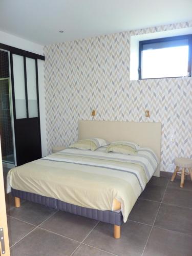 a bedroom with a large bed in a room at La Mésange in Millau
