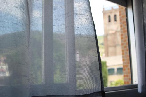 a view of a window with a curtain at Caçula, Alojamento Local in Torre de Moncorvo