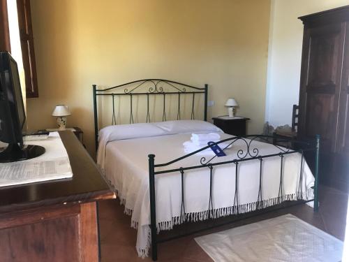 a bedroom with a bed with a white comforter at Hotel Belvedere in Teulada
