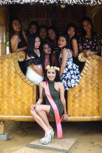 a group of women are posing for a picture at Camaya-an Paradise Beach Resort in Malabugas