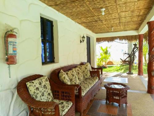 a living room with a couch and chairs and a table at Camaya-an Paradise Beach Resort in Malabugas