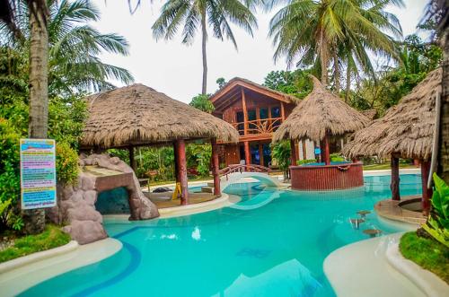 a resort with a swimming pool with a resort at Camaya-an Paradise Beach Resort in Malabugas