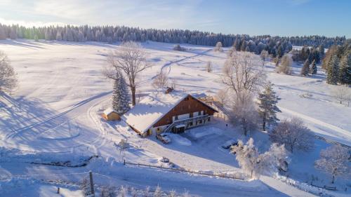 an aerial view of a house in the snow at Le Tillau in Les Verrières-de-Joux