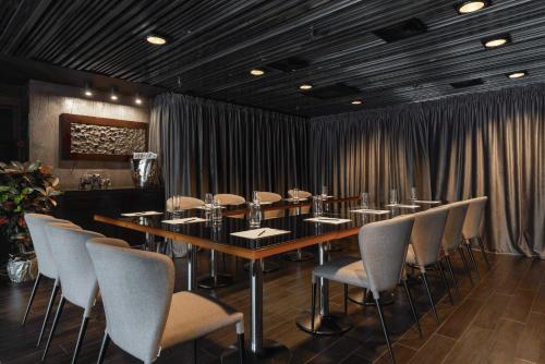 a conference room with a long table and chairs at 11 Mirrors Design Hotel in Kyiv