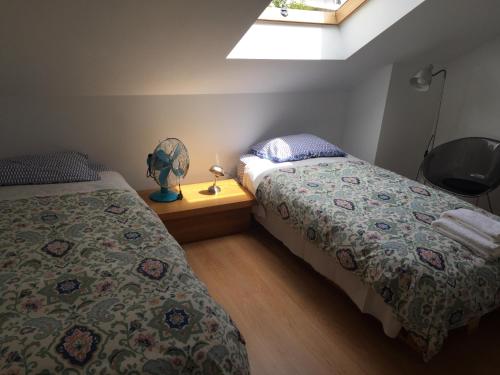 Un dormitorio con 2 camas y una mesa con ventilador. en LX Oriente Loft Apartment, en Lisboa