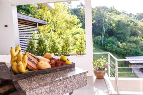 a bowl of fruit on a table on a porch at villa Siam View Samui in Ban Bang Po