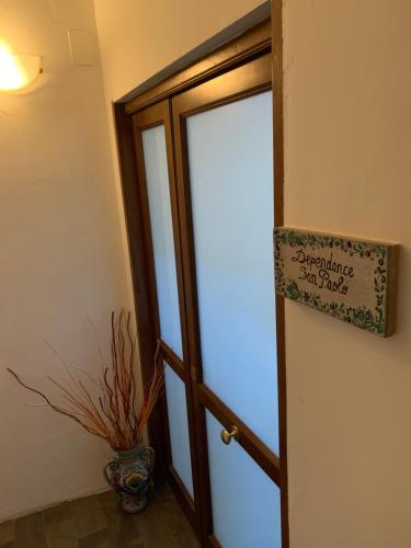 an open door with a sign that reads quarantine stay safe at Apartments Aurora Delle Rose in Assisi