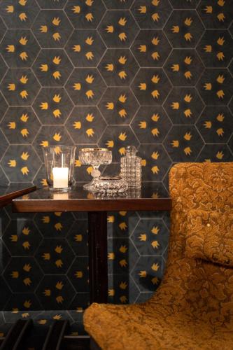 a table in a room with a wall with orange butterflies at Hotel Blu di Te in Santa Margherita Ligure
