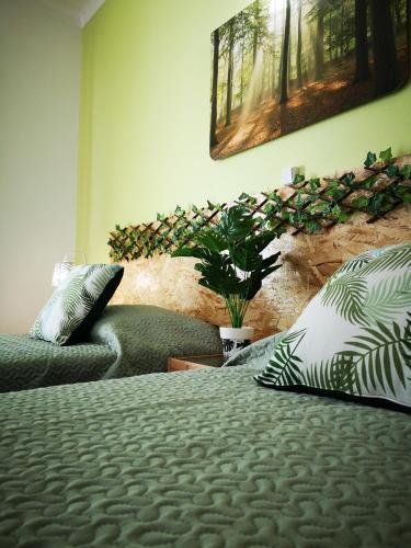 a bedroom with a bed with pillows and a couch at Nature Guesthouse in Lagos