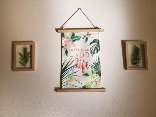 a happy life banner hanging on a wall at Nature Guesthouse in Lagos