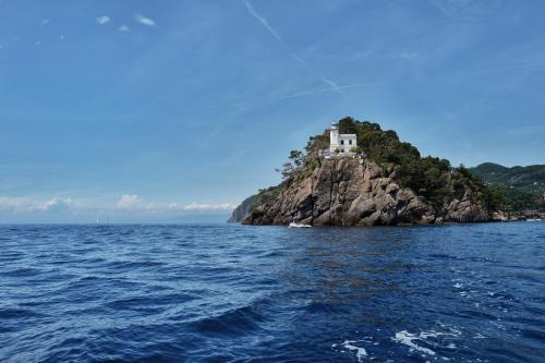 a house on a small island in the water at Hotel Blu di Te in Santa Margherita Ligure
