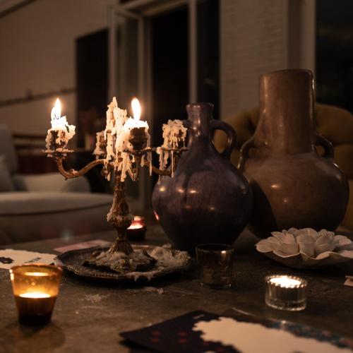 a table with two vases and candles on it at Hotel Blu di Te in Santa Margherita Ligure