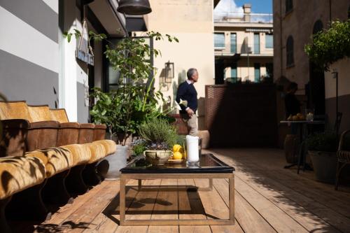 a man standing on a patio with a table at Hotel Blu di Te in Santa Margherita Ligure