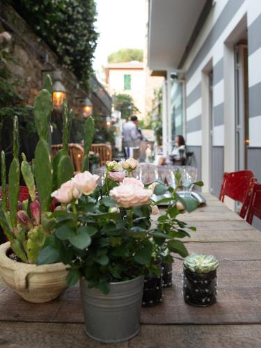 a wooden table with potted plants on a patio at Hotel Blu di Te in Santa Margherita Ligure