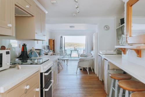 a kitchen with white countertops and a dining room at Falmouth View in Falmouth