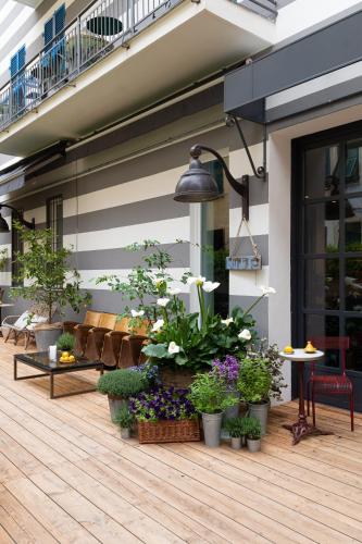 a patio with potted plants on a building at Hotel Blu di Te in Santa Margherita Ligure
