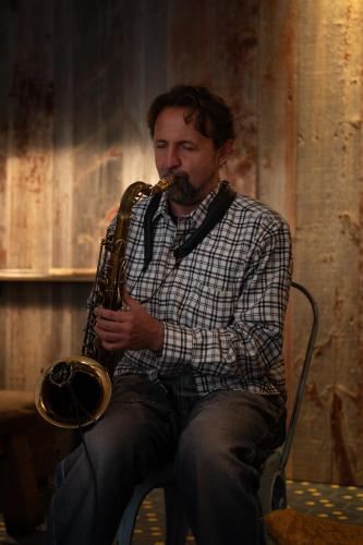 a man sitting in a chair playing a saxophone at Hotel Blu di Te in Santa Margherita Ligure