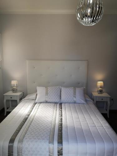 a bedroom with a large bed with two night stands at Nature Guesthouse in Lagos
