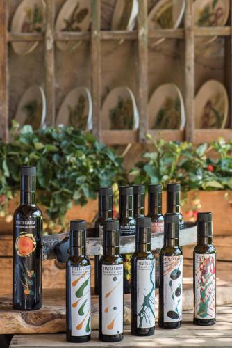 a group of four bottles of essential oils on a table at Relais Sant'Elena in Bibbona