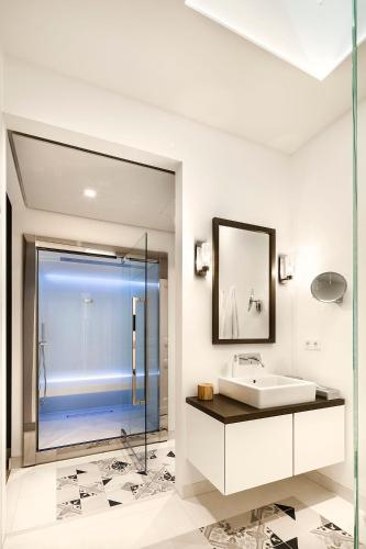 a bathroom with a sink and a glass shower at Lux 11 Berlin-Mitte in Berlin