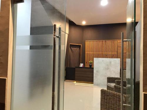 a glass door leading into a room with a desk at villa view2 sayriah in Puncak