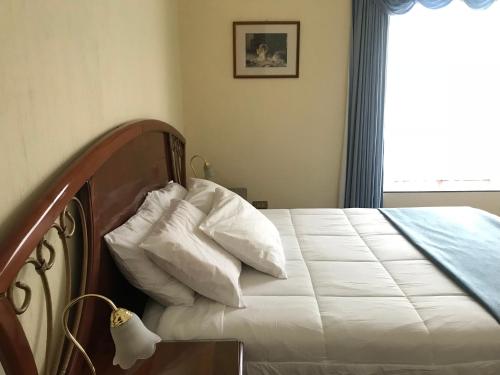 Una cama o camas en una habitación de Hotel Belvedere
