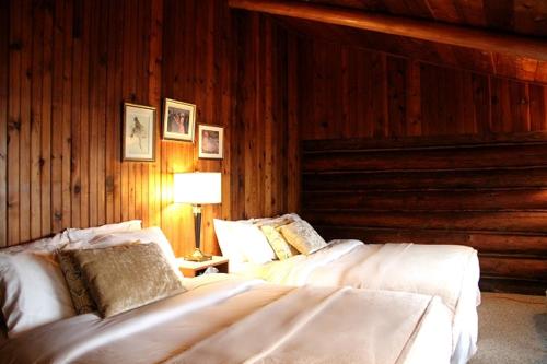 A bed or beds in a room at The Surf Lodge and Pub