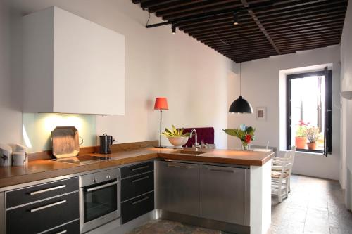 a kitchen with gray cabinets and a wooden counter top at RONDAPLACE in Ronda