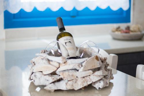 a bottle of wine sitting on top of a table at Poseidon Luxury Apartment in Karpathos Town
