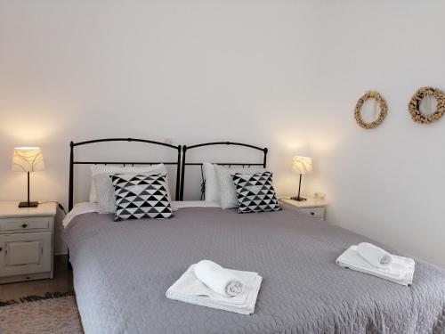 a bedroom with a large bed with two towels on it at Lykomides in Skiros