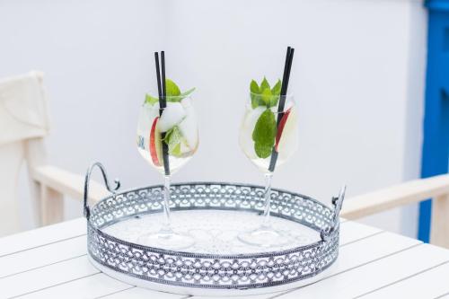 a tray with two vases on top of a table at Poseidon Luxury Apartment in Karpathos Town
