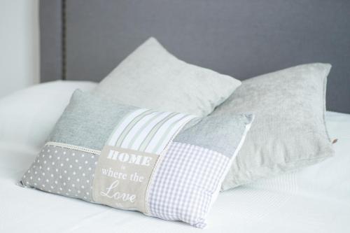 a group of pillows sitting on top of a bed at Poseidon Luxury Apartment in Karpathos Town