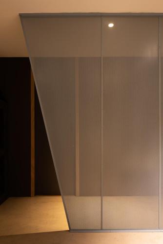a sliding glass door with a triangle pattern on it at Hotel Blu di Te in Santa Margherita Ligure