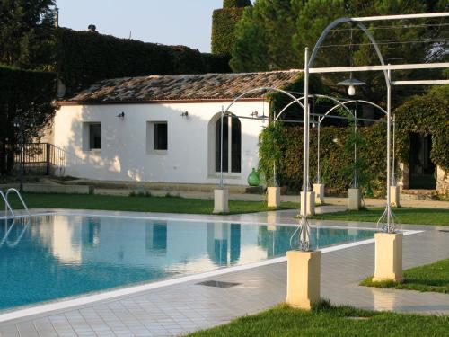 a swimming pool in front of a white building at Tenuta Sant'Andrea in Muro Leccese