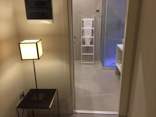 a lamp sitting on a table next to a hallway at Gatto Bianco Duchessa in Bari