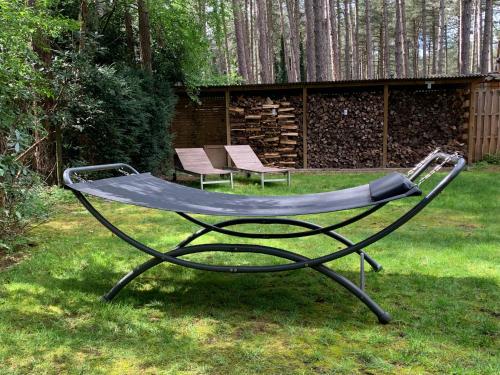 a metal trampoline in a yard with two chairs at Casa Delux in Lille