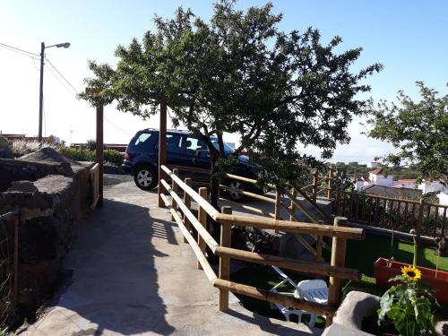 a car parked in a parking lot with a fence at Casa rural meridiano in El Pinar del Hierro