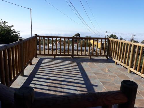 a wooden deck with a view of the ocean at Casa rural meridiano in El Pinar del Hierro