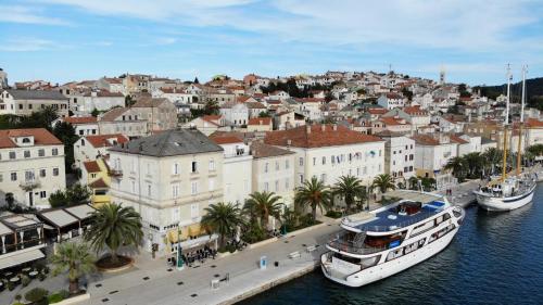 a city with two boats docked in the water at Apartments and Rooms Jospino in Mali Lošinj