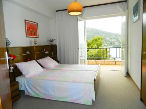 a bedroom with a bed and a balcony at Apartments Mercep in Dubrovnik