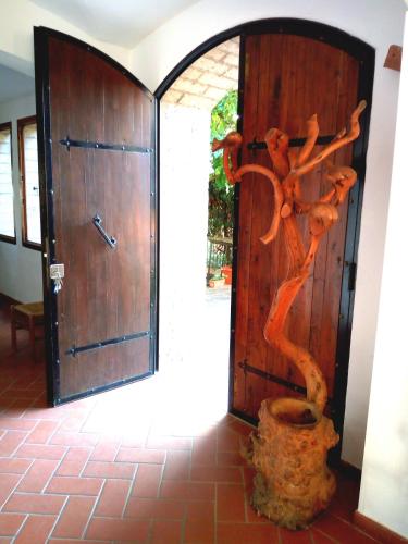 a wooden door with a tree carved into it at ROMANTICA TOSCANA in Scarlino