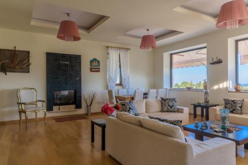 a living room with a couch and a table at Eco Villa Makri in Makri