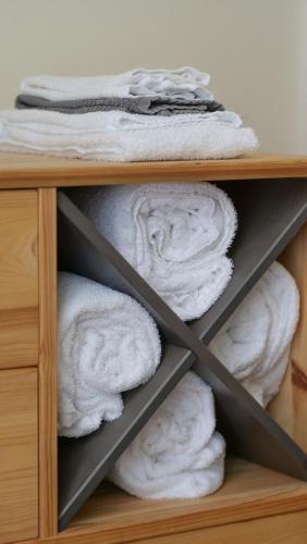 a shelf filled with towels in a closet at Casa da Matriz in Ponta Delgada