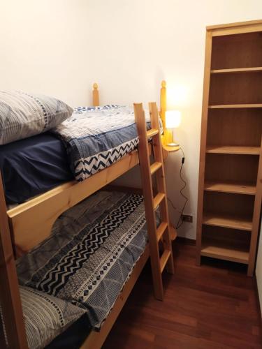 a bedroom with two bunk beds and a lamp at Plodn House in Sappada