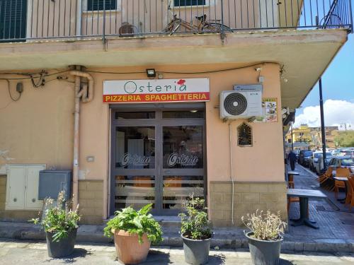 a restaurant with a sign on the side of a building at Aspra al delfino blu in Bagheria